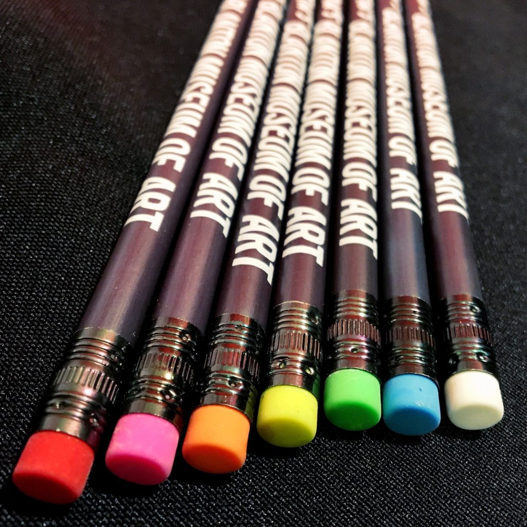 seven black pencils stamped with the blanton logo, each with a different brightly colored eraser