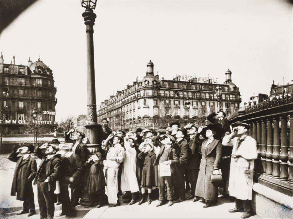 The crowd gathered in Paris’s Place de la Bastille on April 17, 1912, was observing a solar eclipse through viewing apparatuses.