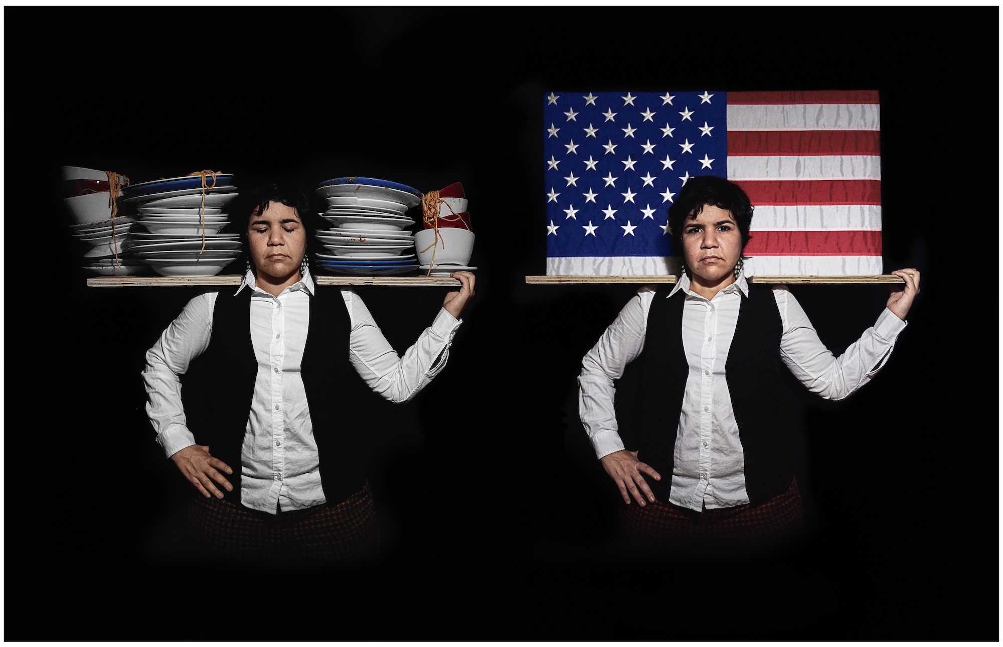 The same person poses twice in an image. In the first position, she has her eyes closed and holds a shelf of dirty dishes on her shoulders. The second is the US flag on a shelf on her shoulders. The person wears a black waistcoat over a white shirt..