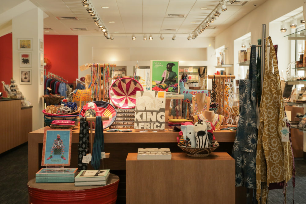 Picture of the Blanton Museum of Art Museum Shop. The photo is showcasing a variety of items that are available for purchase ranging from books, decor, and clothing.