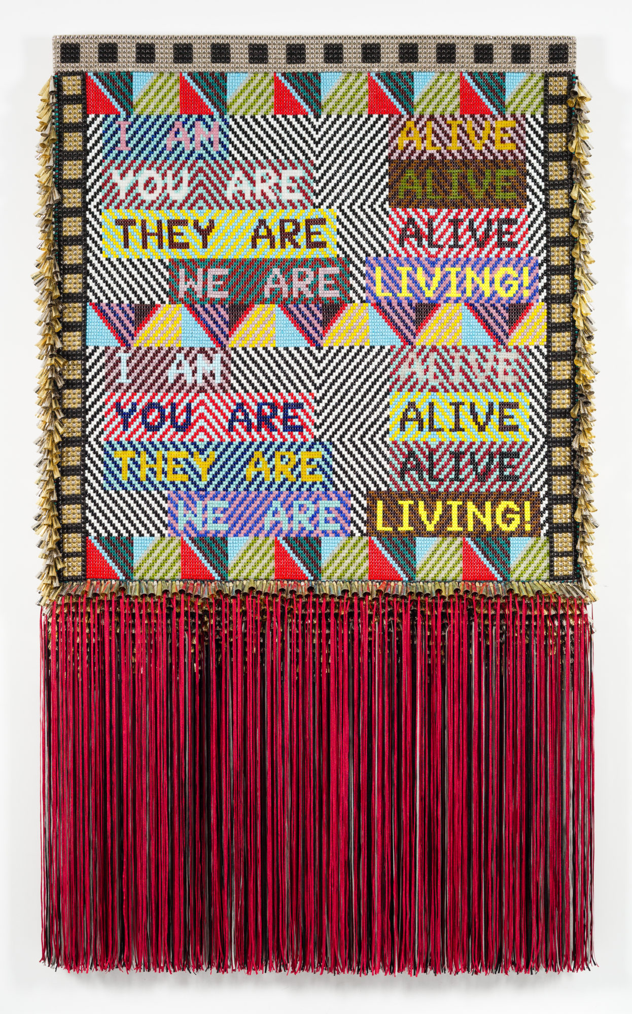 Jeffrey Gibson's art titled ALIVE! covered in colorful beads used to make text, and tin jingles