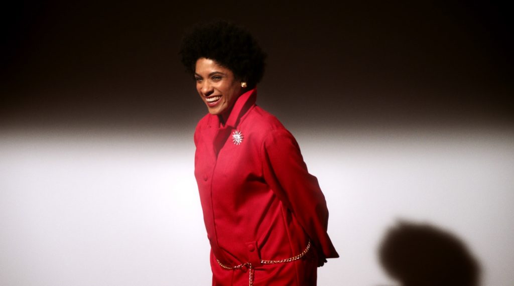 A woman wearing a red suit. 