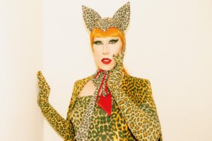 woman with orange hair in leopard print suit
