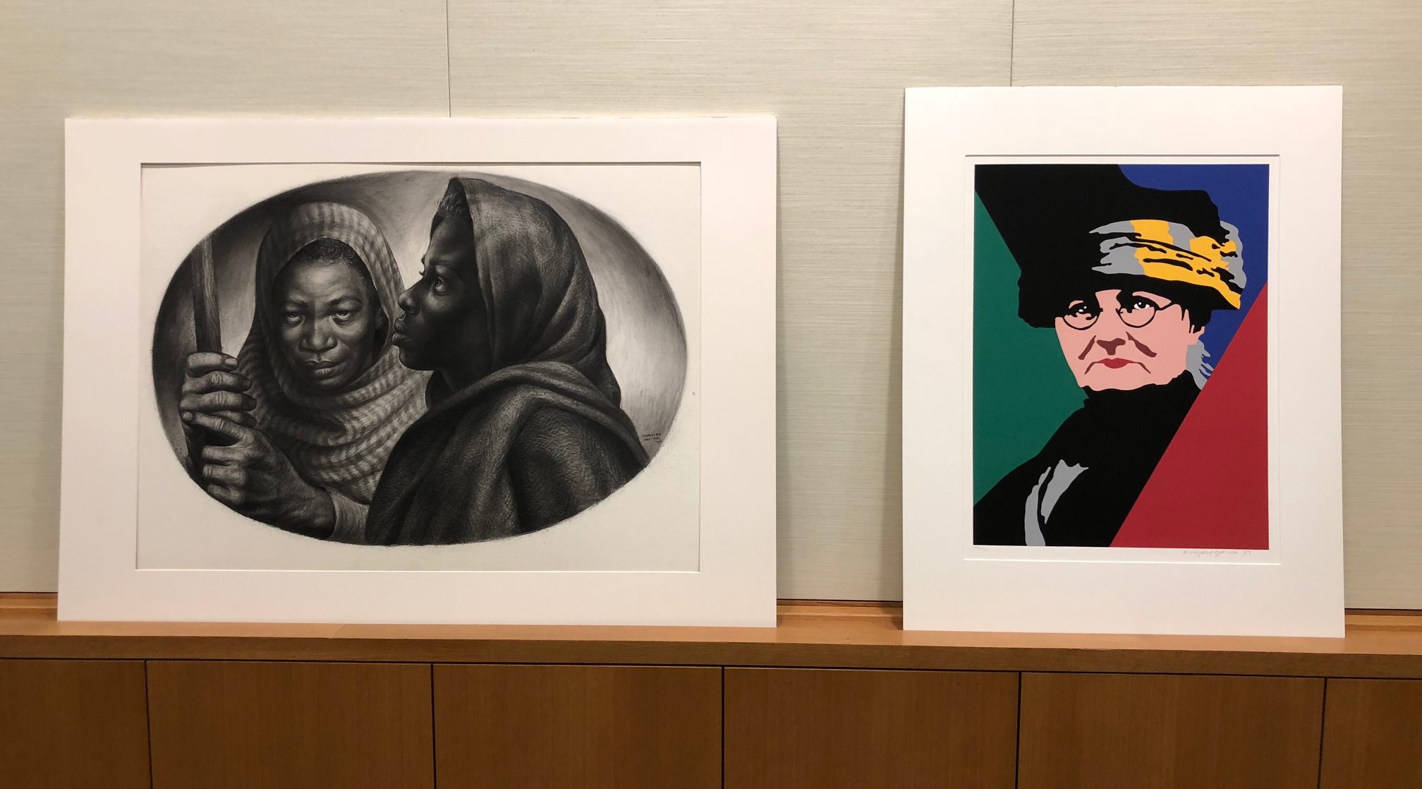 Two prints displayed at the Wonder Women in Art pop up exhibition, one depicts General Moses and Sojourner Truth, the other is a pop art print of a woman