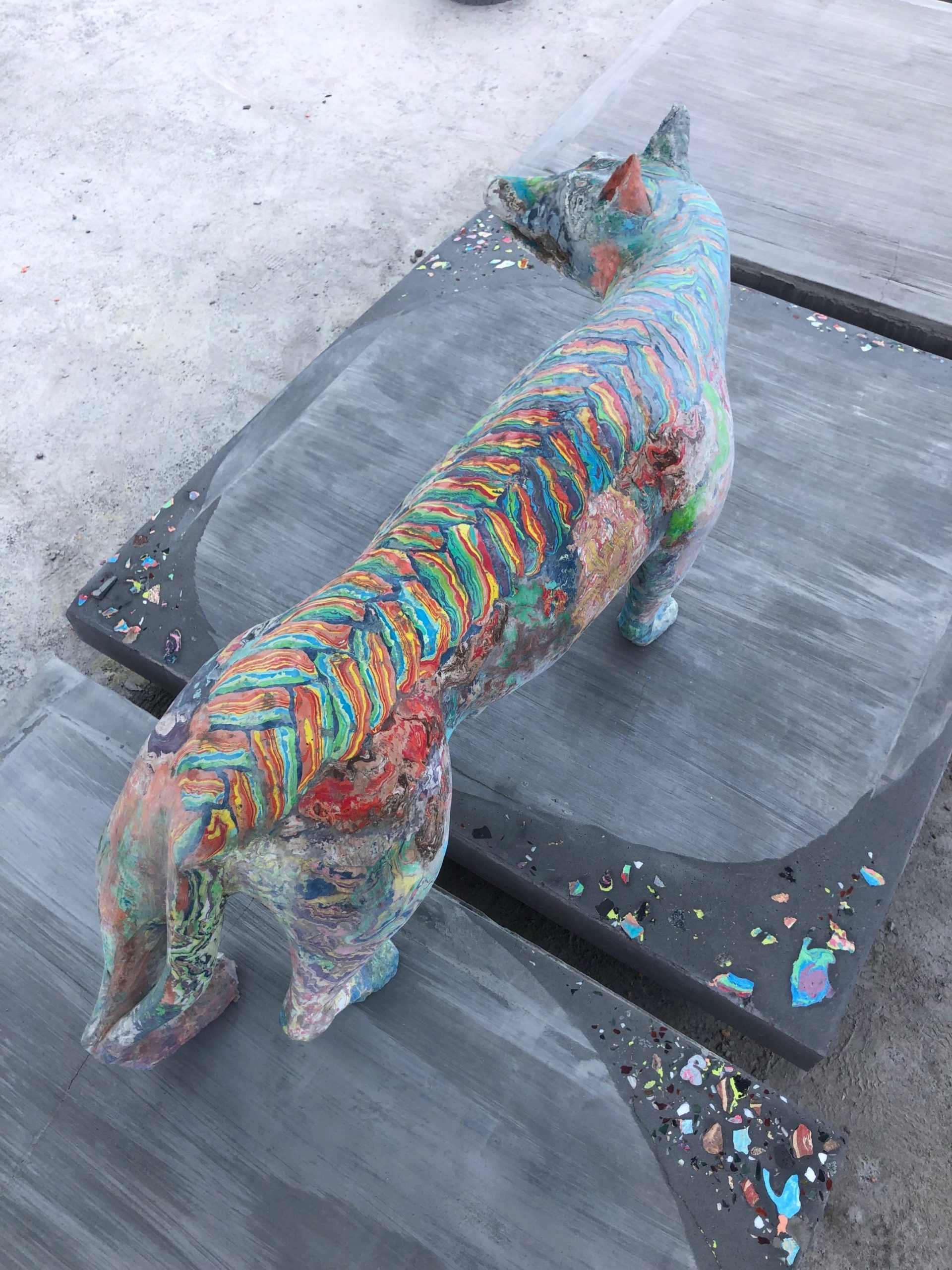Top of She-Wolf and Ramp sculpture by Lily Cox-Richard, depicting a multicolored she-wolf on a sidewalk