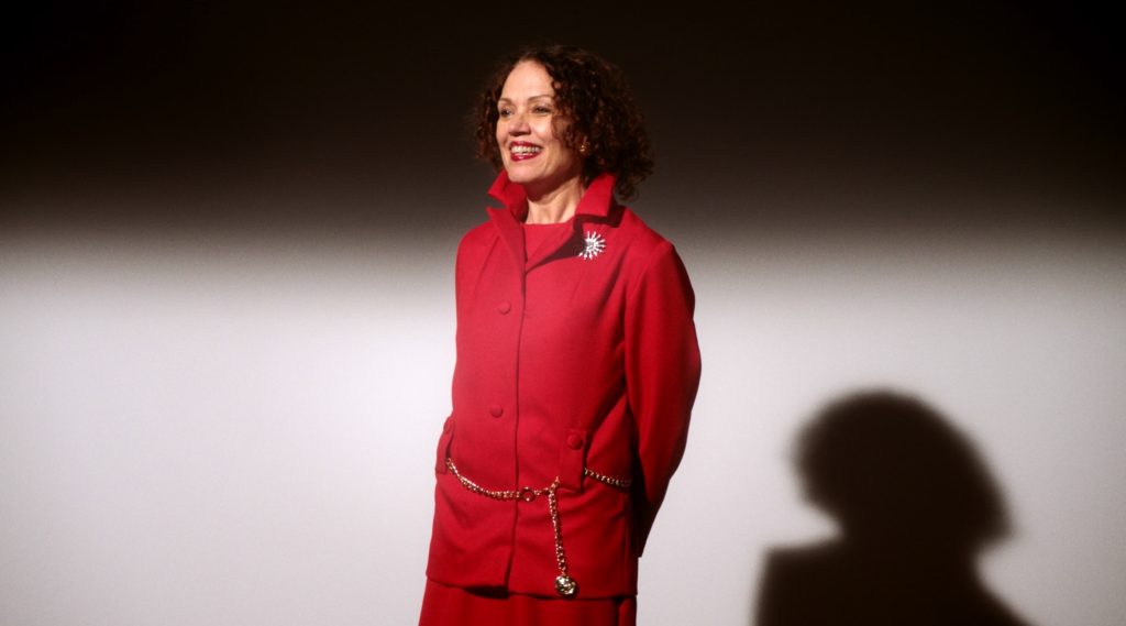 A woman wearing a red suit. 