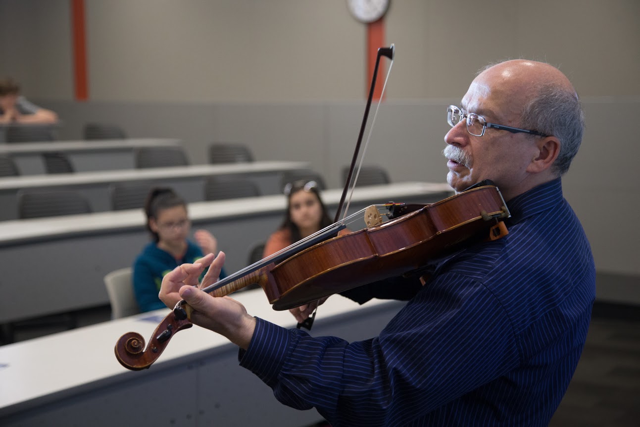 Viola player and UT psychology professor Michael Domjan playing his viola