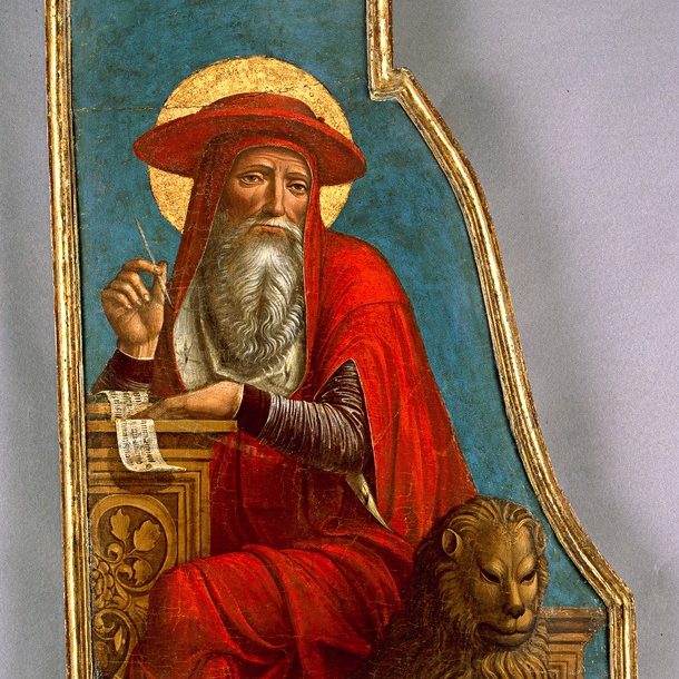 Image depicts St. Jerome at a writing desk, wearing a bright red robe and hat. He is sitting on a seat with a gold lion's head in front of a torquoise background.
