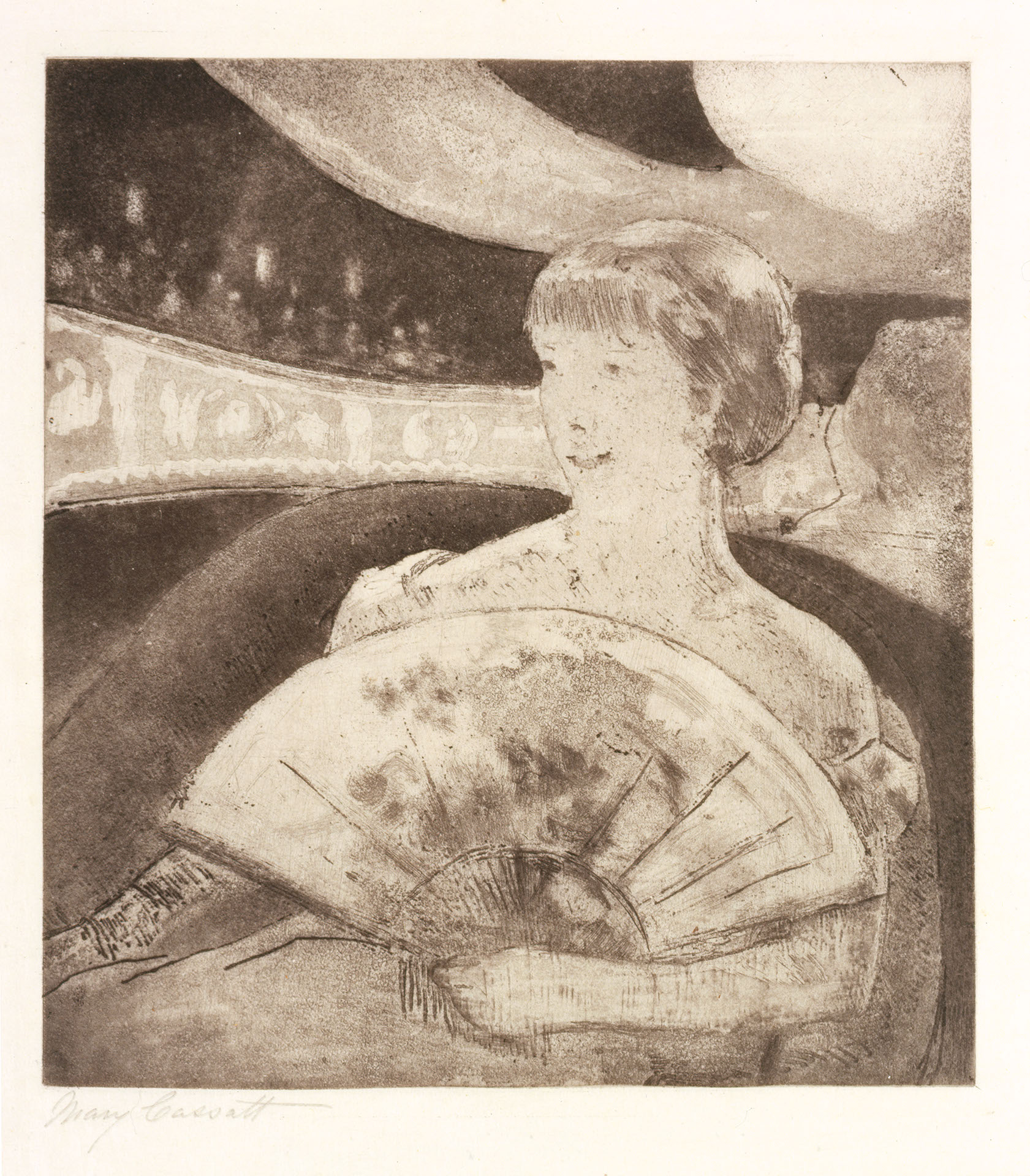View of a woman holding a large fan in her lap seated in a plush chair at the theater