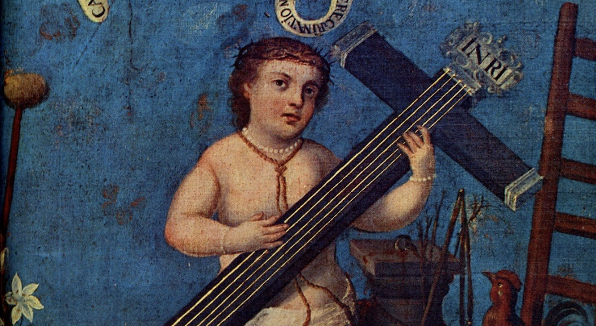 Christ child playing a cross which has strings like a guitar.