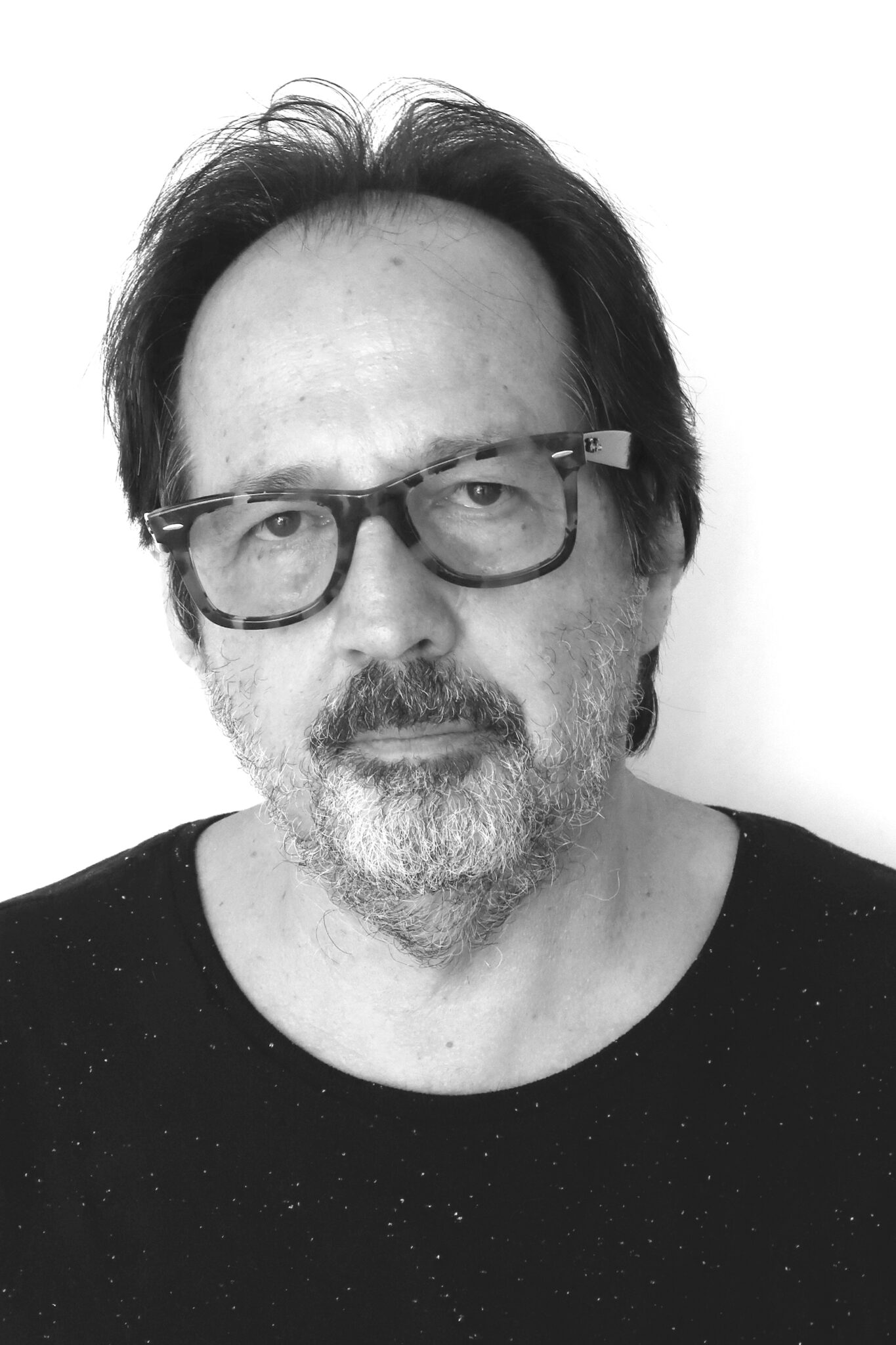 Headshot of a man wearing dark glasses.