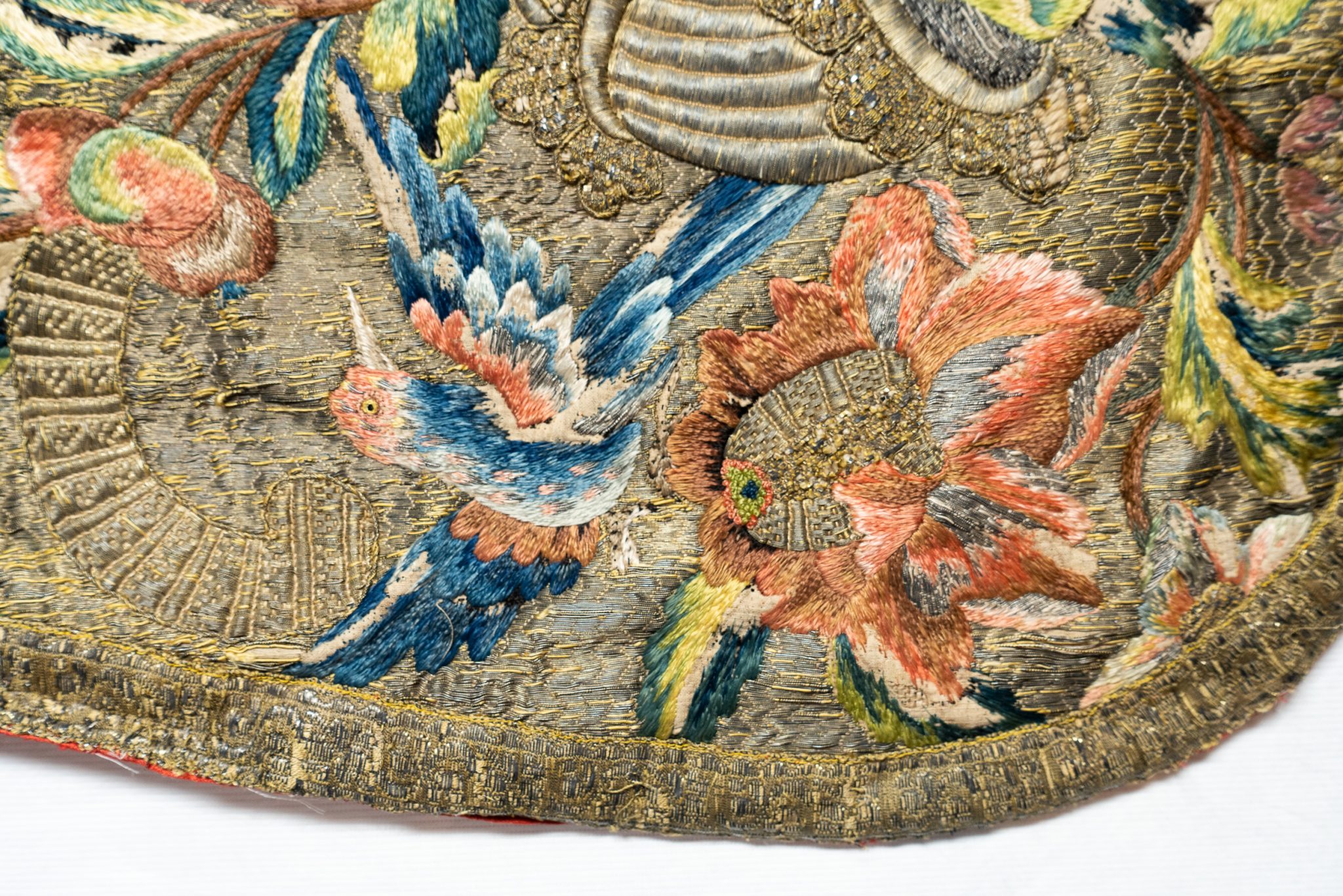 A detail of an embroidered chasuble, cover with birds and flowers