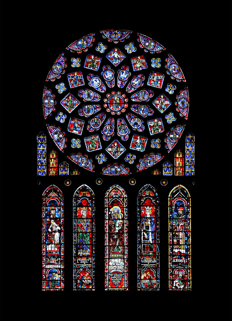 a brightly colored, circular stained-glass window with several vertical stained-glass panels below