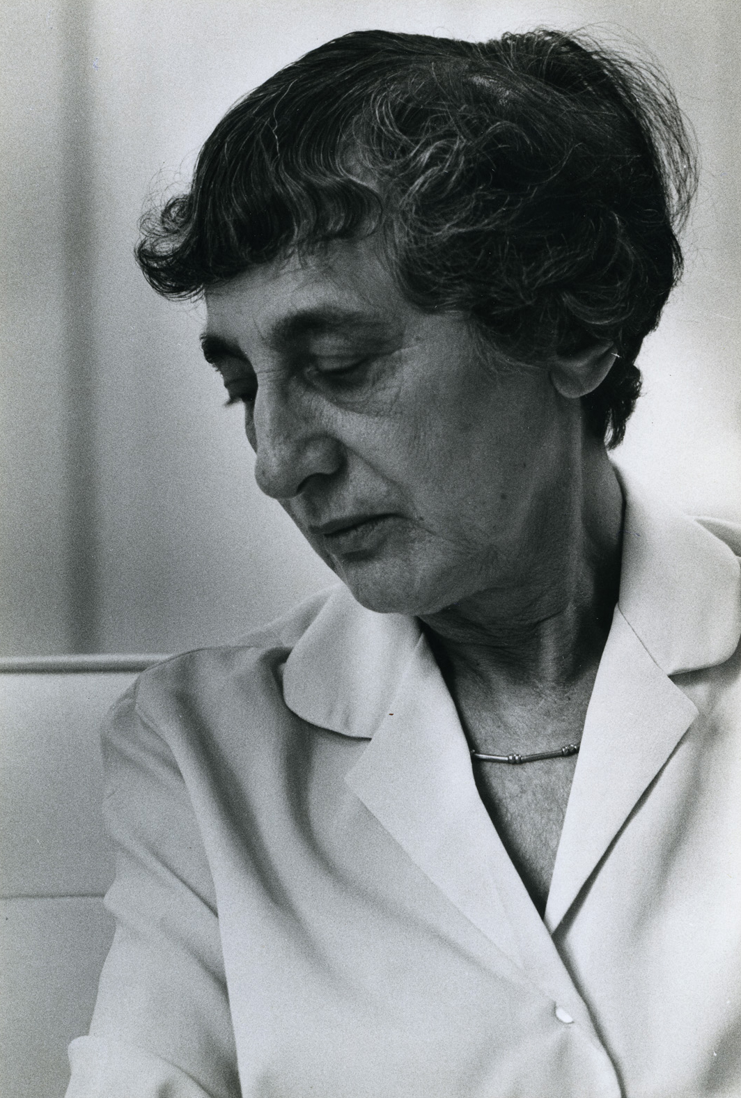 A black-and-white photograph of Anni Albers looking down
