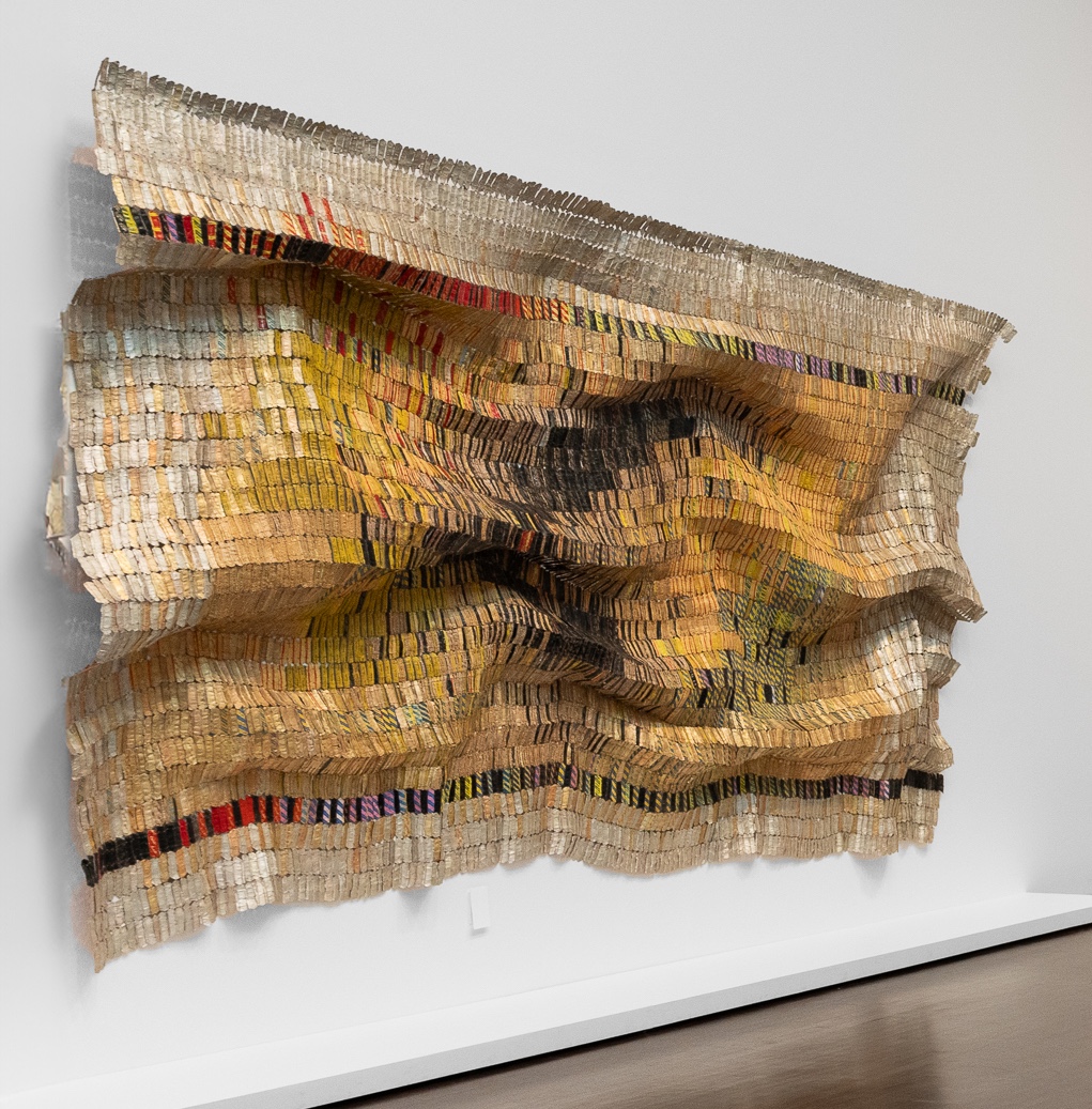 A large artwork hung on the wall, constructed with Aluminum and copper wire