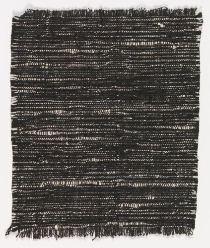 A small, black-and-white woven textile