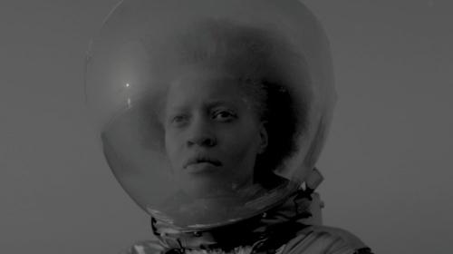 film still from Frances Bodomo, "Afronauts" figure with an afro in a space helmet