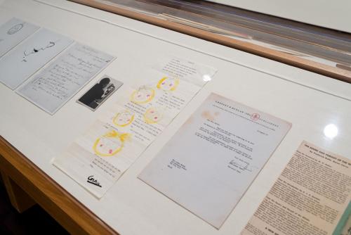 Prints and typed and handwritten letters in a display case