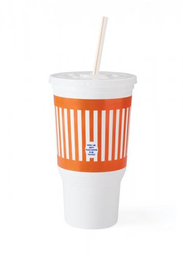 A fast-food drink cupwith orange and whitestripes against a whitebackground