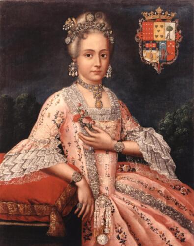 A young white woman wearing a pink dress decorated with lace at the low neck and fluffy sleeves,wears rich jewelry made of pearlswhile firmly looking back to the spectator.